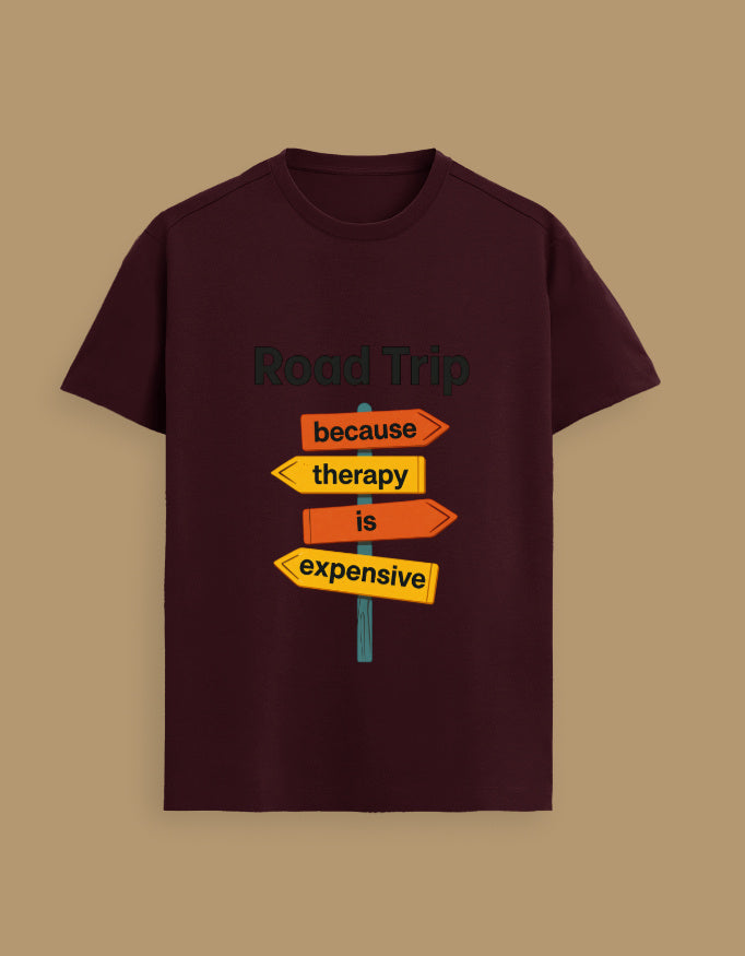 Maroon Unisex Supima T-Shirt with colorful road sign graphic and humorous travel quote, ideal for vacation and adventure lovers.